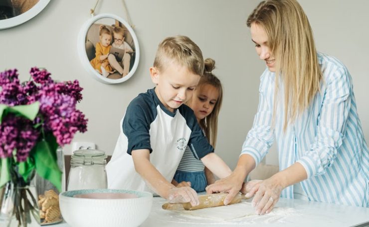 Mother and children enjoying a fun and messy baking session together at home.